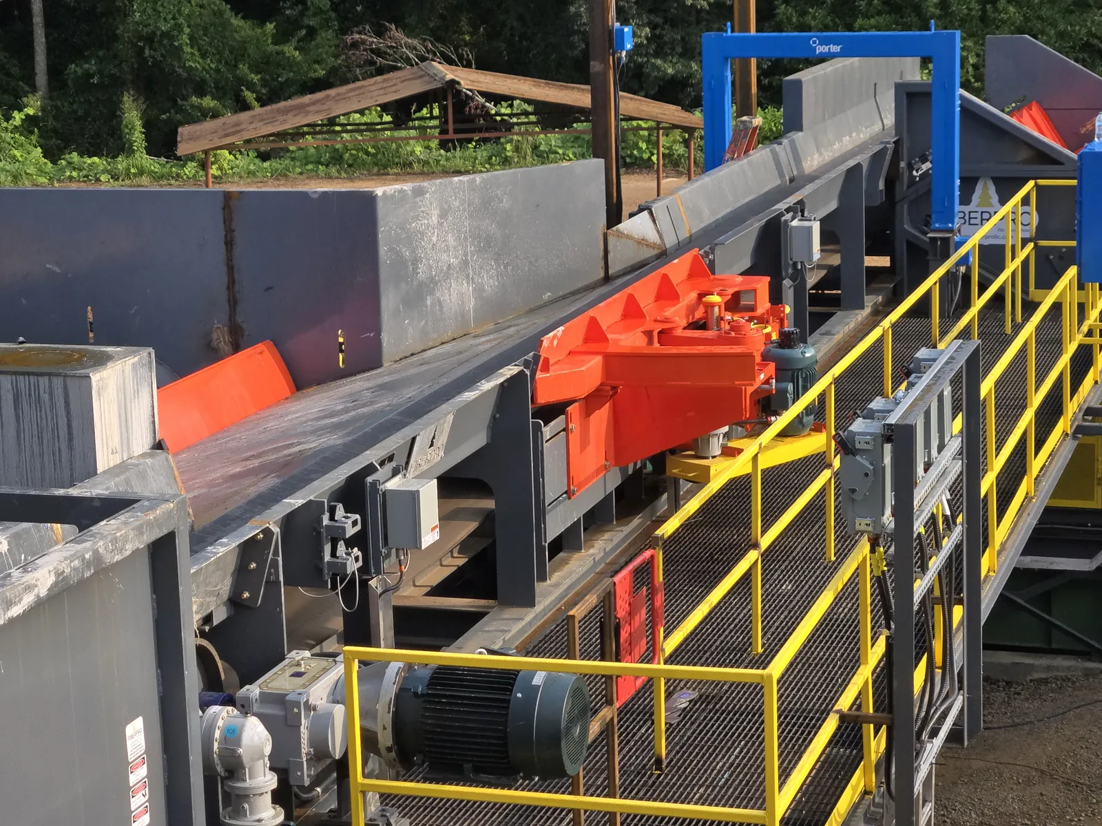 E-Sweep kicker mounted beside a log conveyor